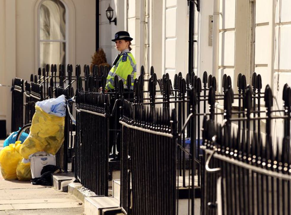 On guard: A PCSO outside a house in London where a body was found