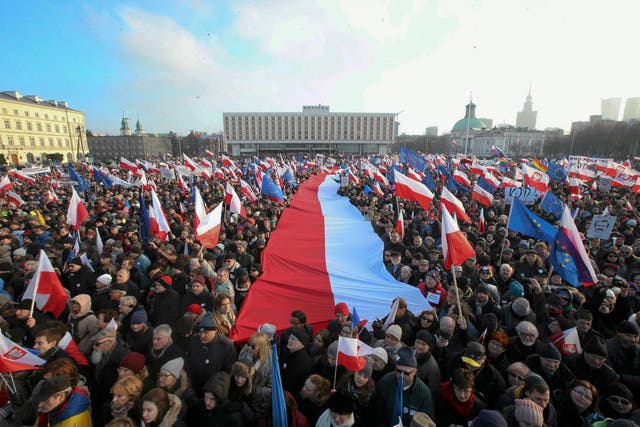 People hold EU and Polish national flags during a demonstration in Warsaw, Poland February 27, 2016.