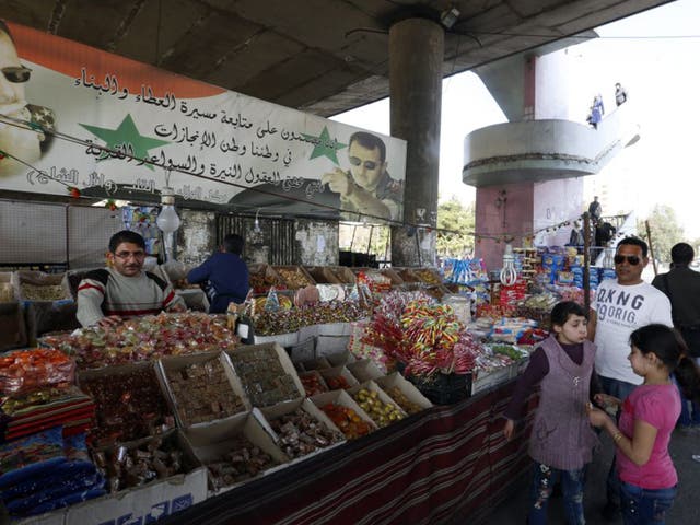 A family ventures out to a Damascus market on the first day of the Syria ceasefire