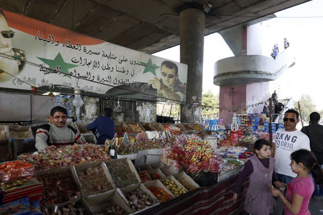 A family ventures out to a Damascus market on the first day of the Syria ceasefire