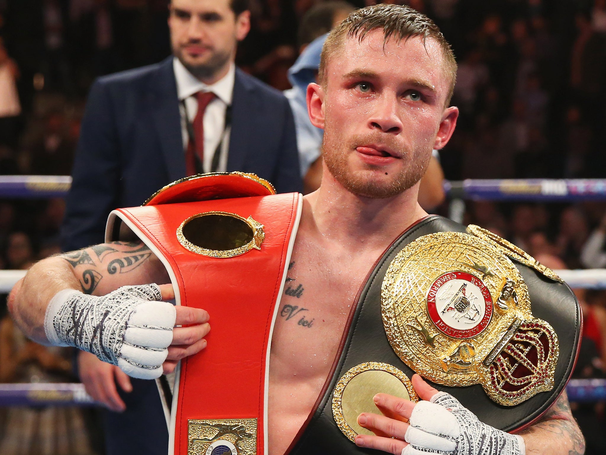 Frampton poses with his two super-bantamweight belts