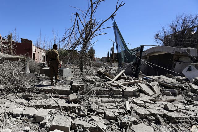 A Yemeni inspects the damage following a Saudi-led airstrike targeting a neighborhood in Sana'a, Yemen, 27 February 2016.
