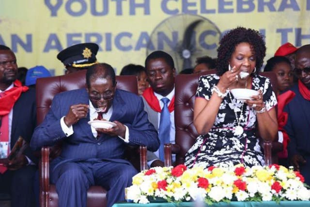 Robert Mugabe and his wife Grace at his party