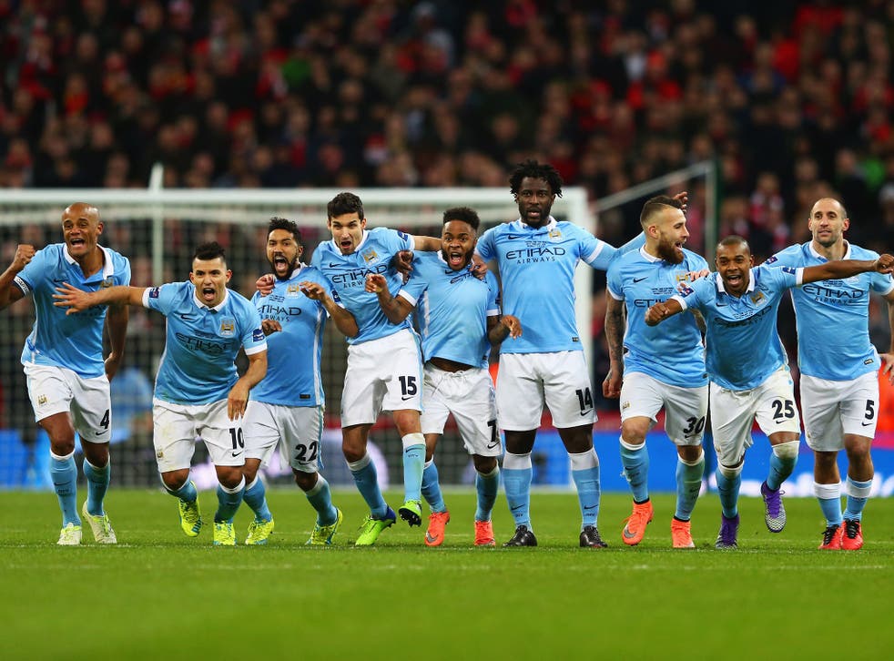 Manchester City's players react to Yaya Toure's winning penalty