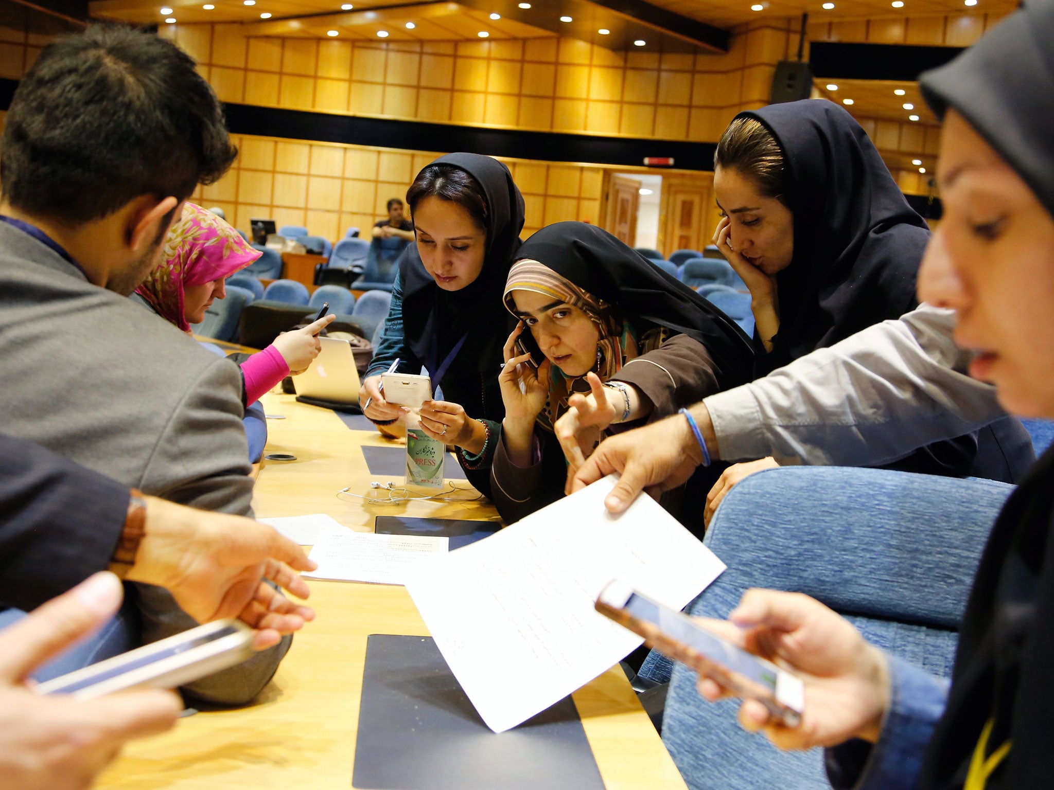 Iranian journalists follow the preliminary results of parliamentary and Experts Assembly elections at the Interior Ministry, in Tehran, Iran