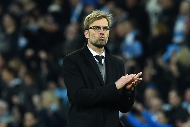 A disappointed Jürgen Klopp applauds the Liverpool fans at the end of the match
