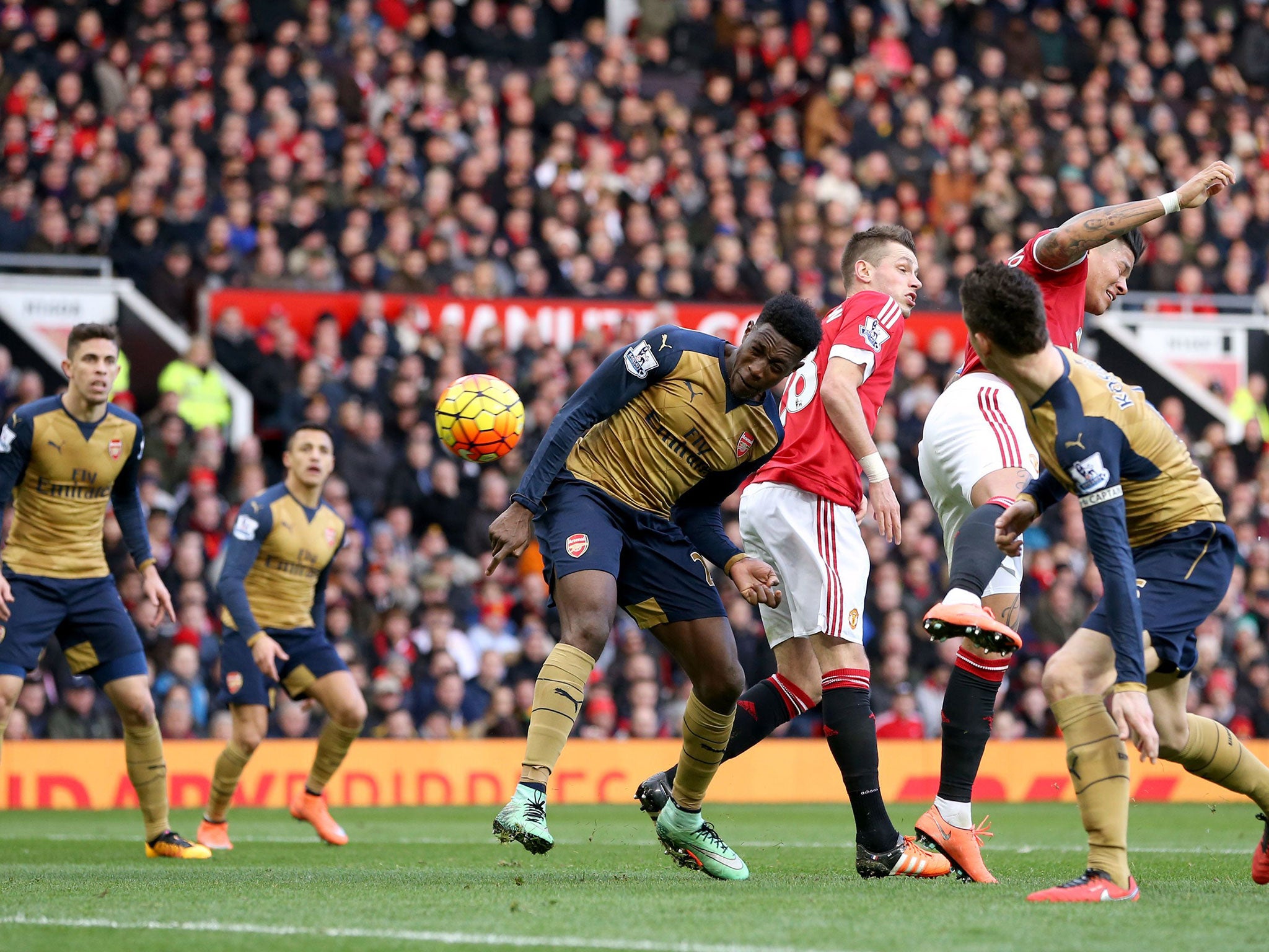 Danny Welbeck, center, scores for Arsenal in the defeat by his old club Manchester United