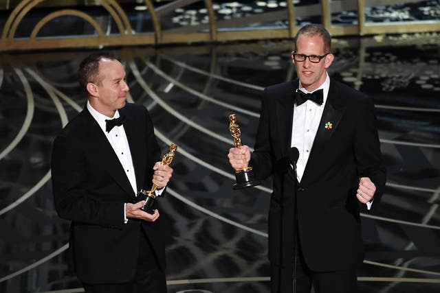 Producer Jonas Rivera (L) and director Pete Docter accept the Best Animated Feature Film award for 'Inside Out'