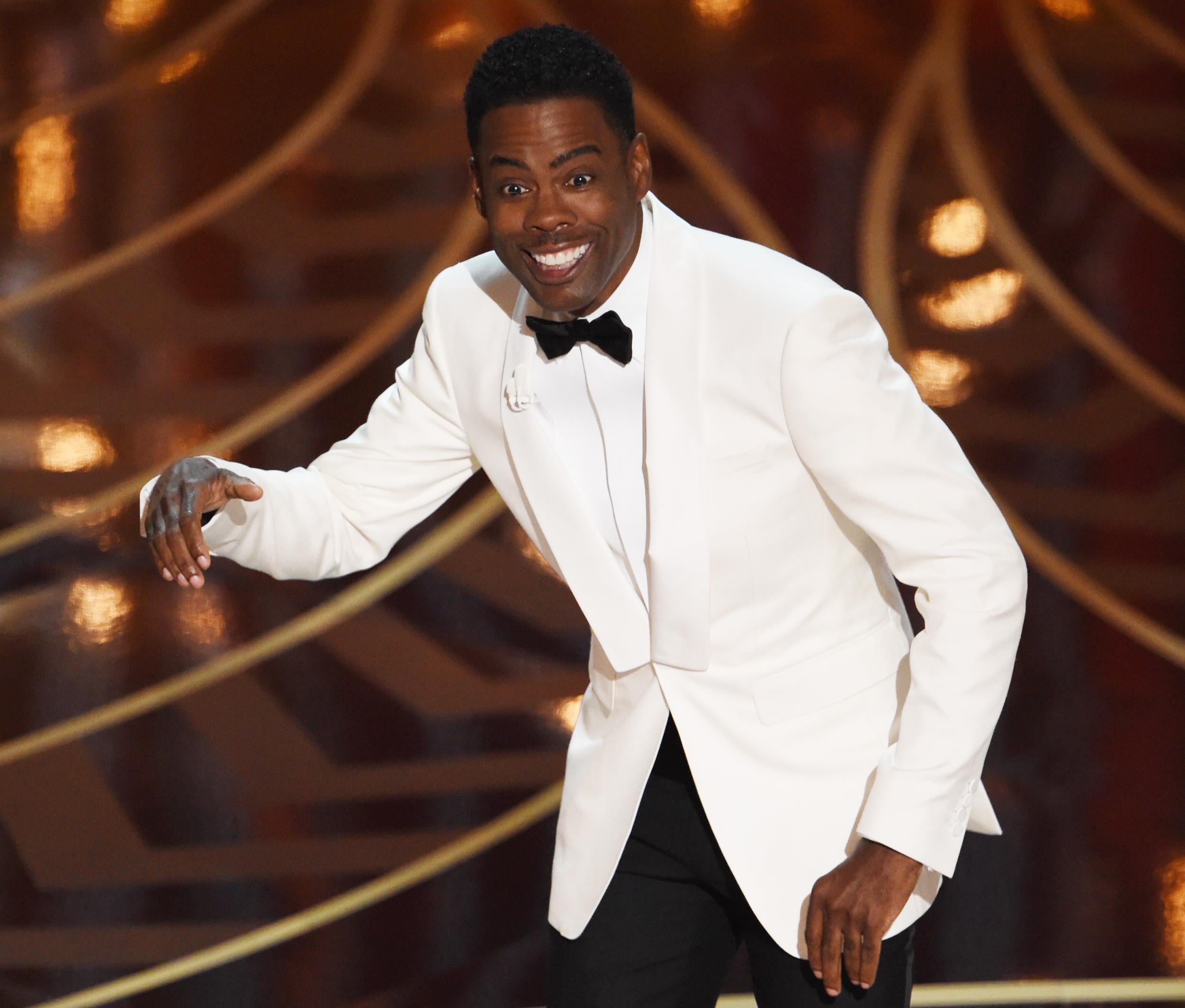 Chris Rock hosting the 88th Academy Award clad in a white tuxedo