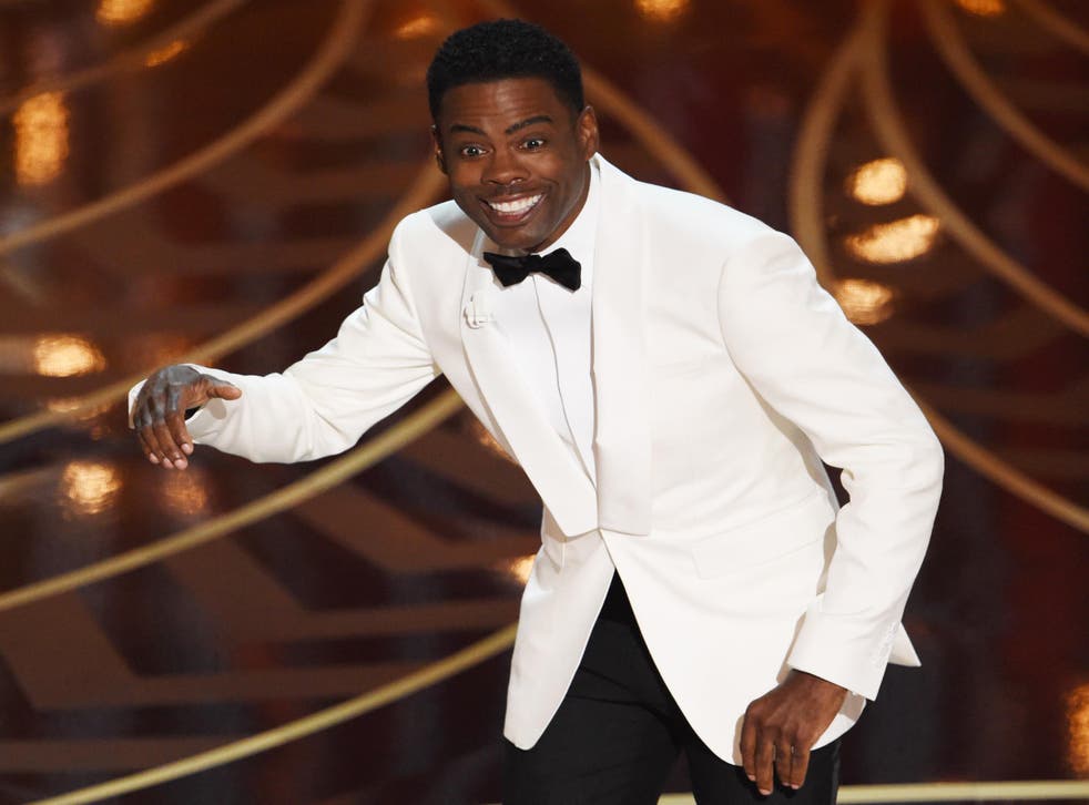 Chris Rock hosting the 88th Academy Award clad in a white tuxedo