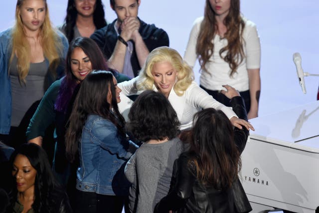 Lady Gaga (C) performs onstage during the 88th Annual Academy Awards at the Dolby Theatre