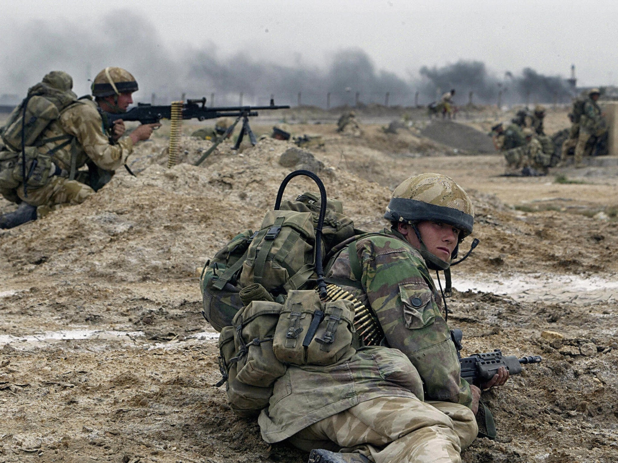 &#13;
British soldiers take cover in Basra in southern Iraq in 2003 (Getty)&#13;