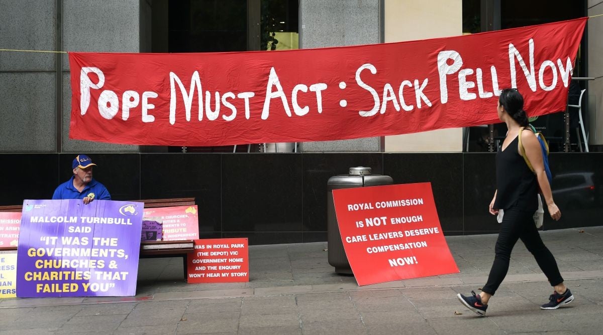 Protesters outside the Royal Commission headquarters in Sydney demand Pope Francis fire Cardinal Pell over the alleged cover-up of abuse in Ballarat