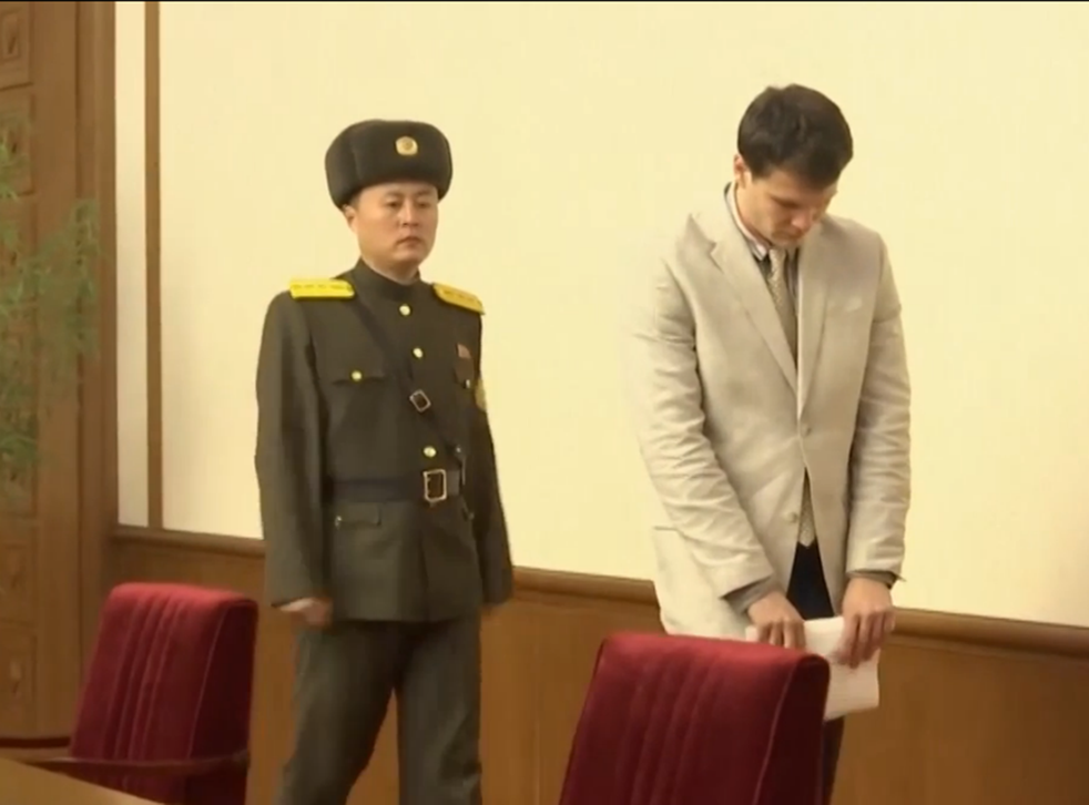 Otto Warmbier escorted by a North Korean guard