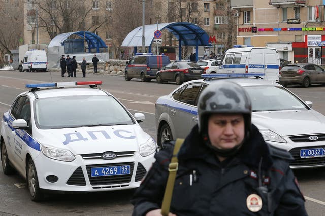 A Russian police officer stands at the site where a woman suspected of murdering a young child was detained, near Oktyabrskoye Pole metro station in Moscow