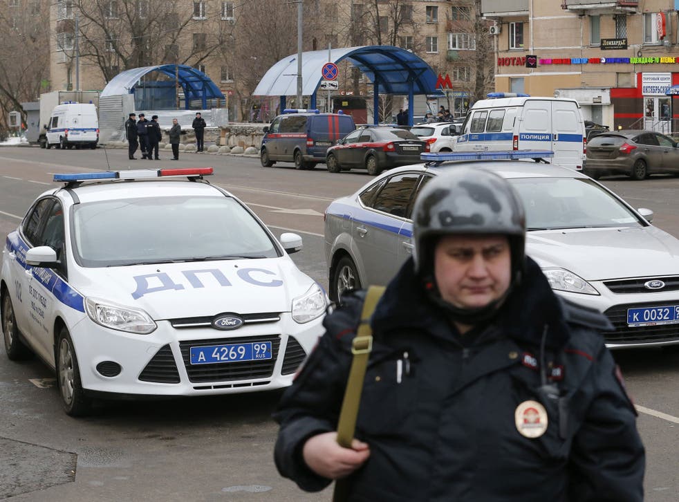 A Russian police officer stands at the site where a woman suspected of murdering a young child was detained, near Oktyabrskoye Pole metro station in Moscow