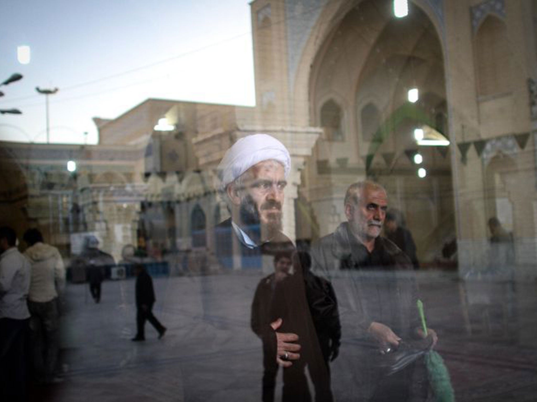 A cleric waits to cast his ballot papers at a polling station in Qom, during elections for Iran’s parliament, the Majlis, and the Assembly of Experts