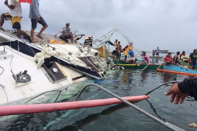 Fishermen recover the yacht off Barobo in the Philippines, in which the mummified sailor was discovered