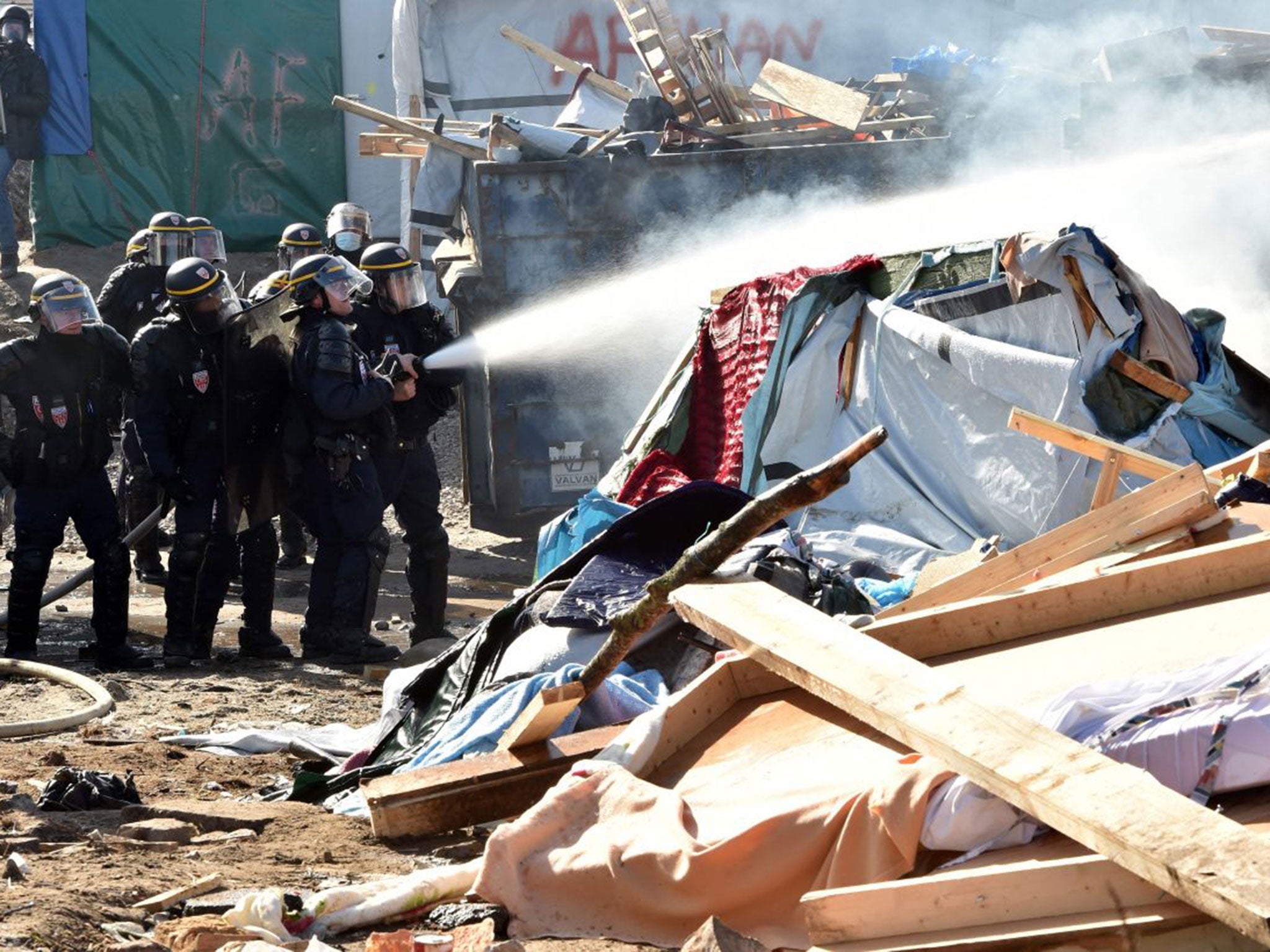 Riot police extinguish a fire during Monday's clashes