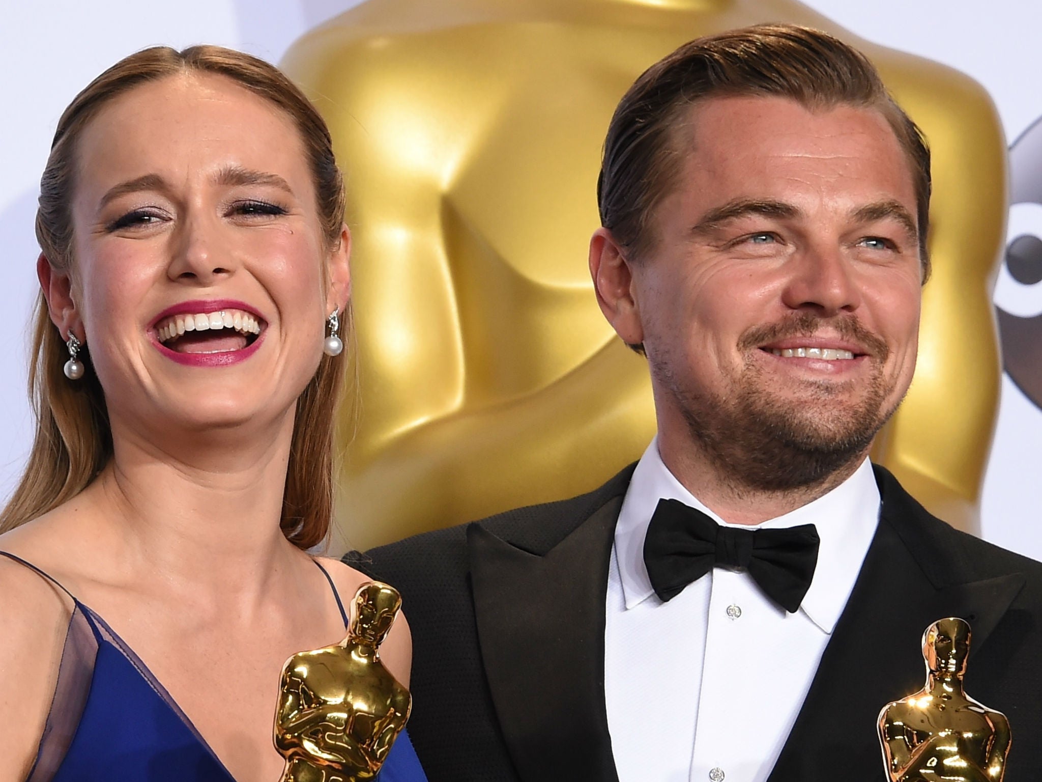 Brie Larson and Leonardo DiCaprio pose with their Oscars in the press room
