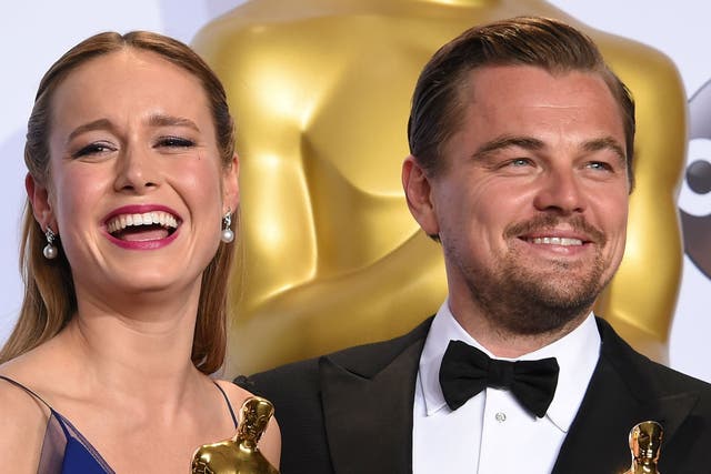 Brie Larson and Leonardo DiCaprio pose with their Oscars in the press room