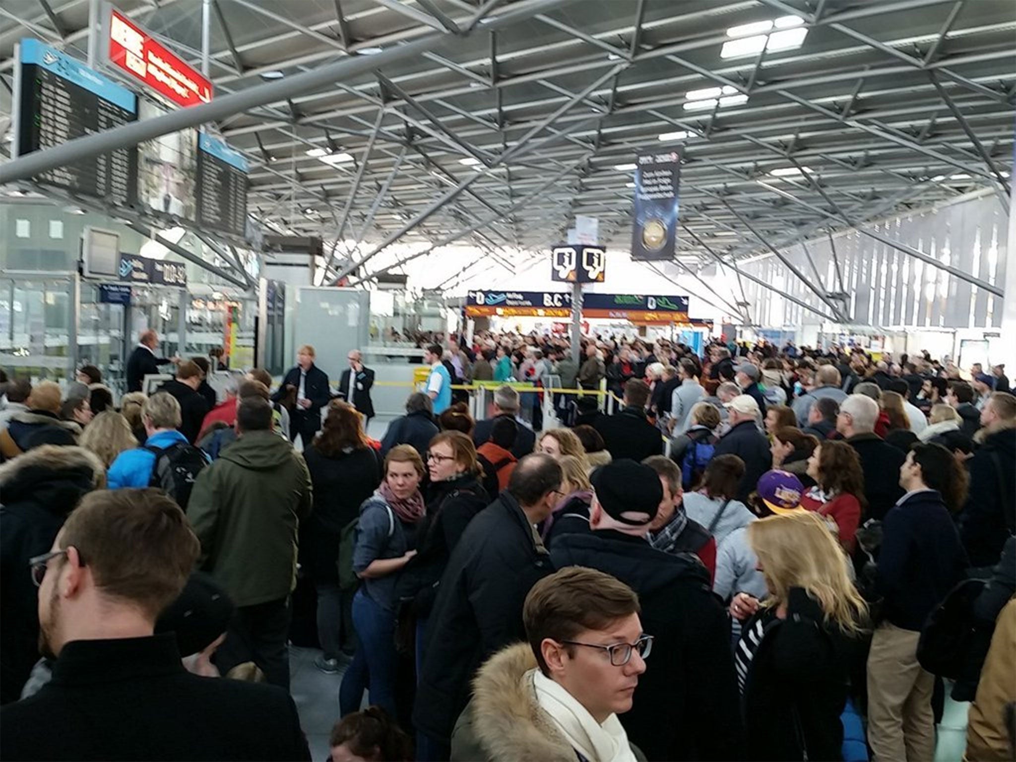 Passengers seen evacuating the Cologne airport terminals