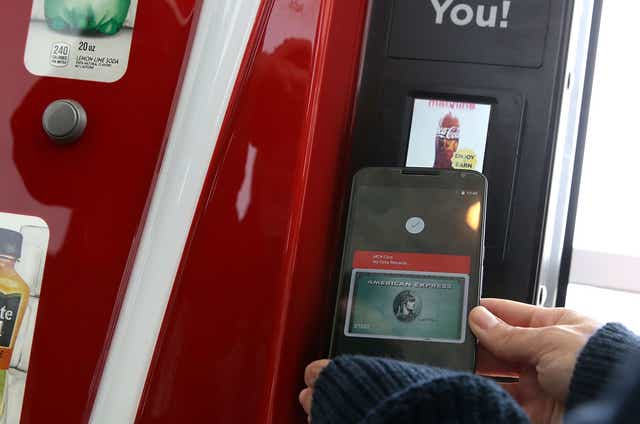 Someone uses Android pay to buy a drink from a vending machine at Google's I/O conference in 2015