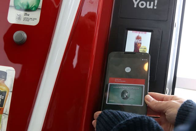 Someone uses Android pay to buy a drink from a vending machine at Google's I/O conference in 2015