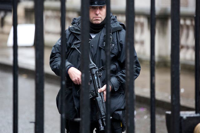 A police officer stands guard at the security gates at Downing Street in London