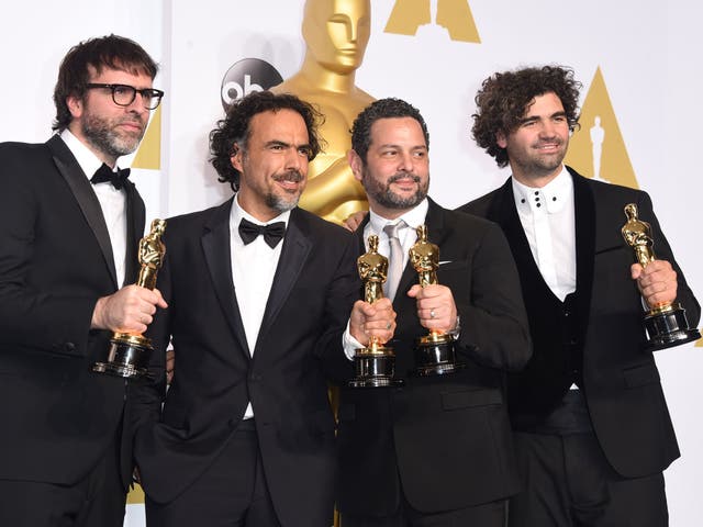 Nicolas Giacobone, Alejandro Gonzalez Inarritu, Alexander Dinelaris and Armando Bo pose with their Oscars for Best Original Screenplay for Birdman