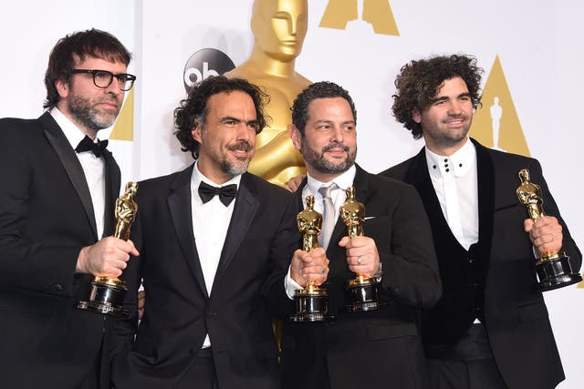 Nicolas Giacobone, Alejandro Gonzalez Inarritu, Alexander Dinelaris and Armando Bo pose with their Oscars for Best Original Screenplay for Birdman