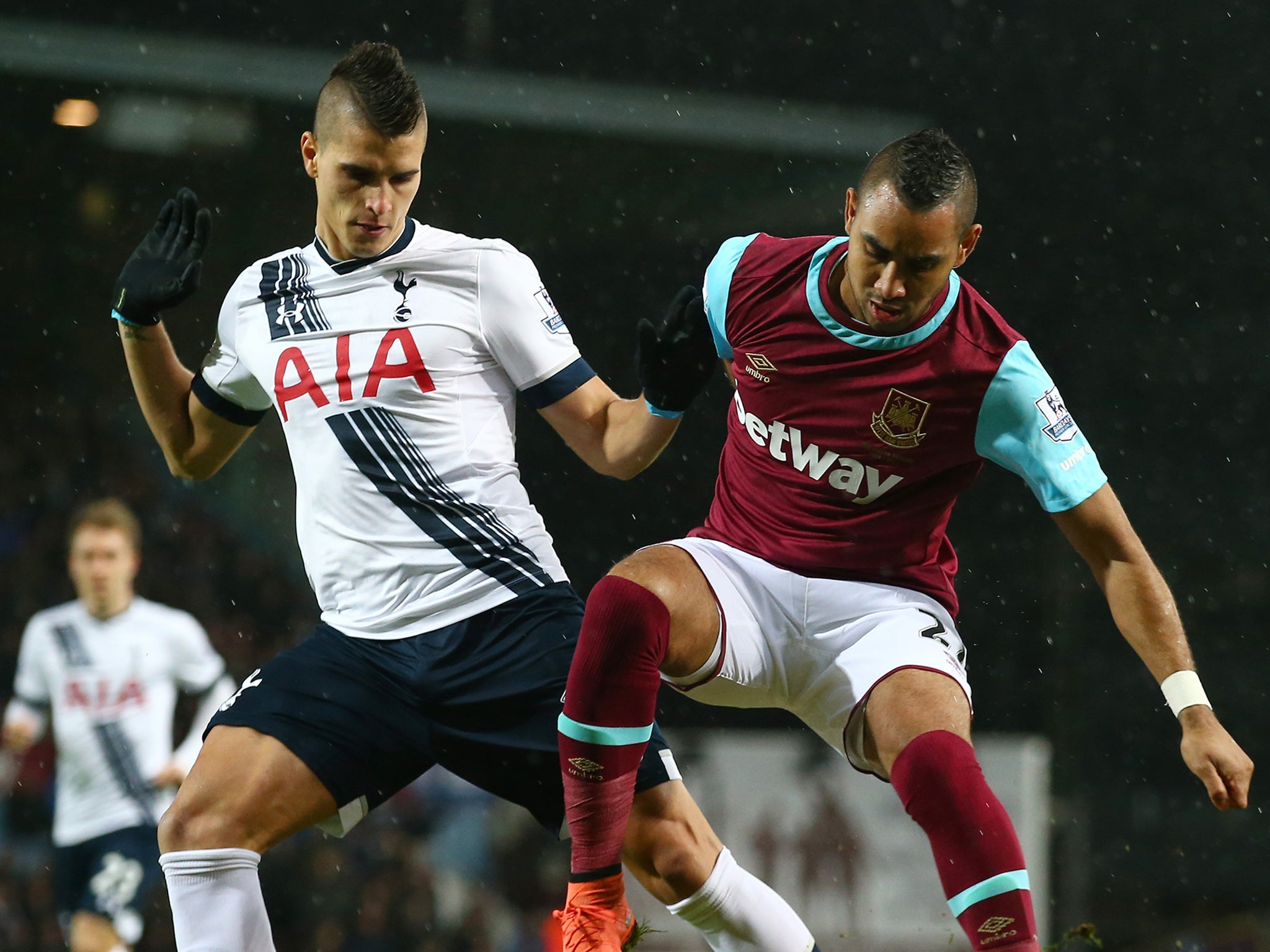 Erik Lamela and Dimitri Payet compete for the ball