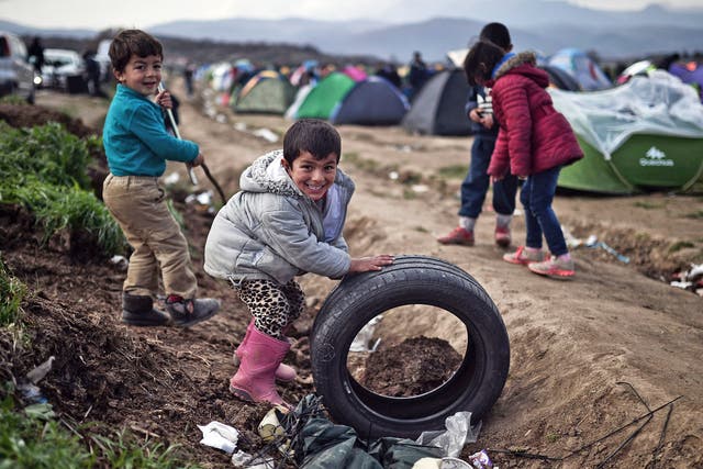 Children play in a makeshift refugee camp at the Greek-Macedonian border