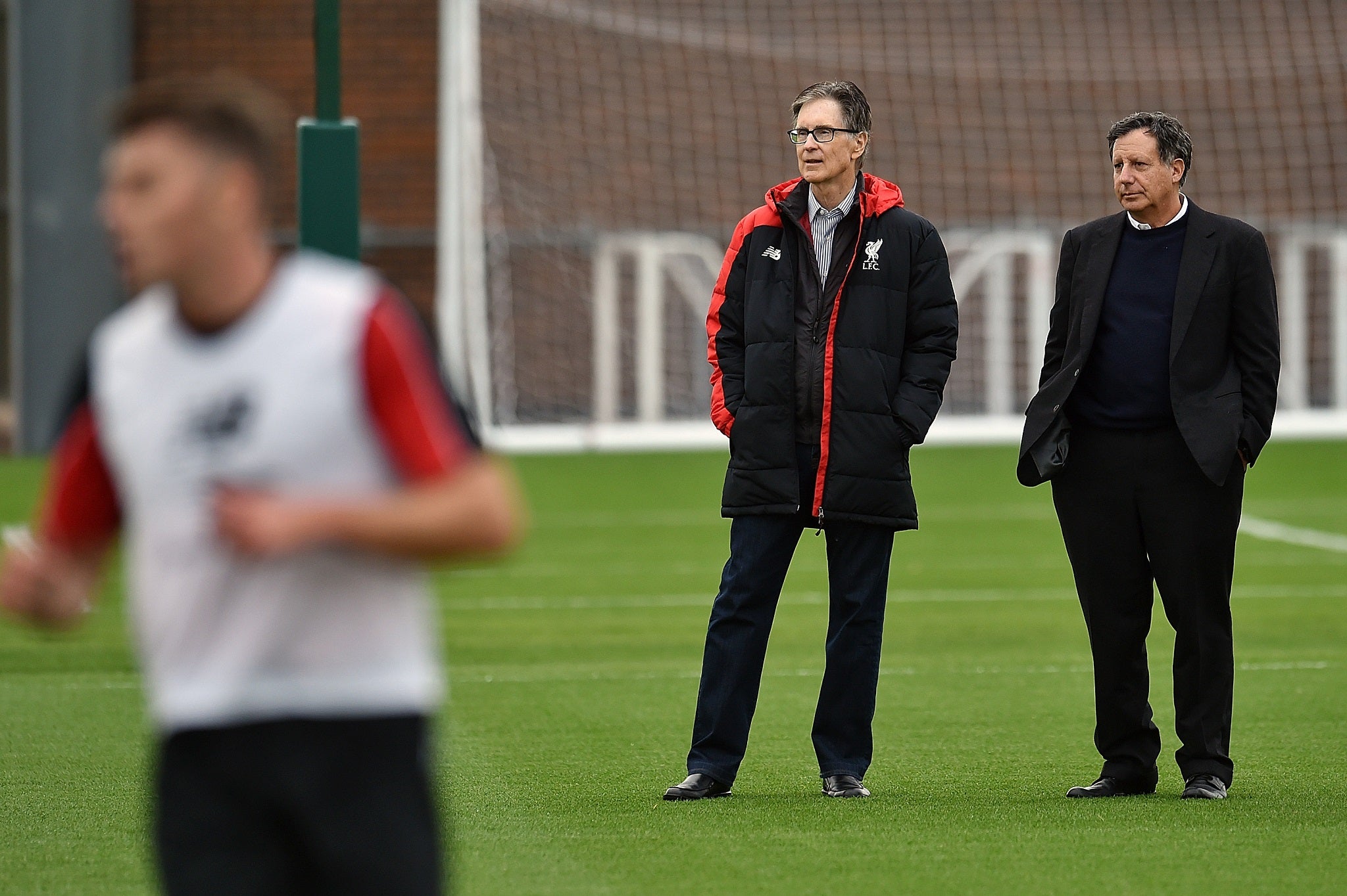 Liverpool part owners John W Henry and Tom Werner watch a training session at Melwood