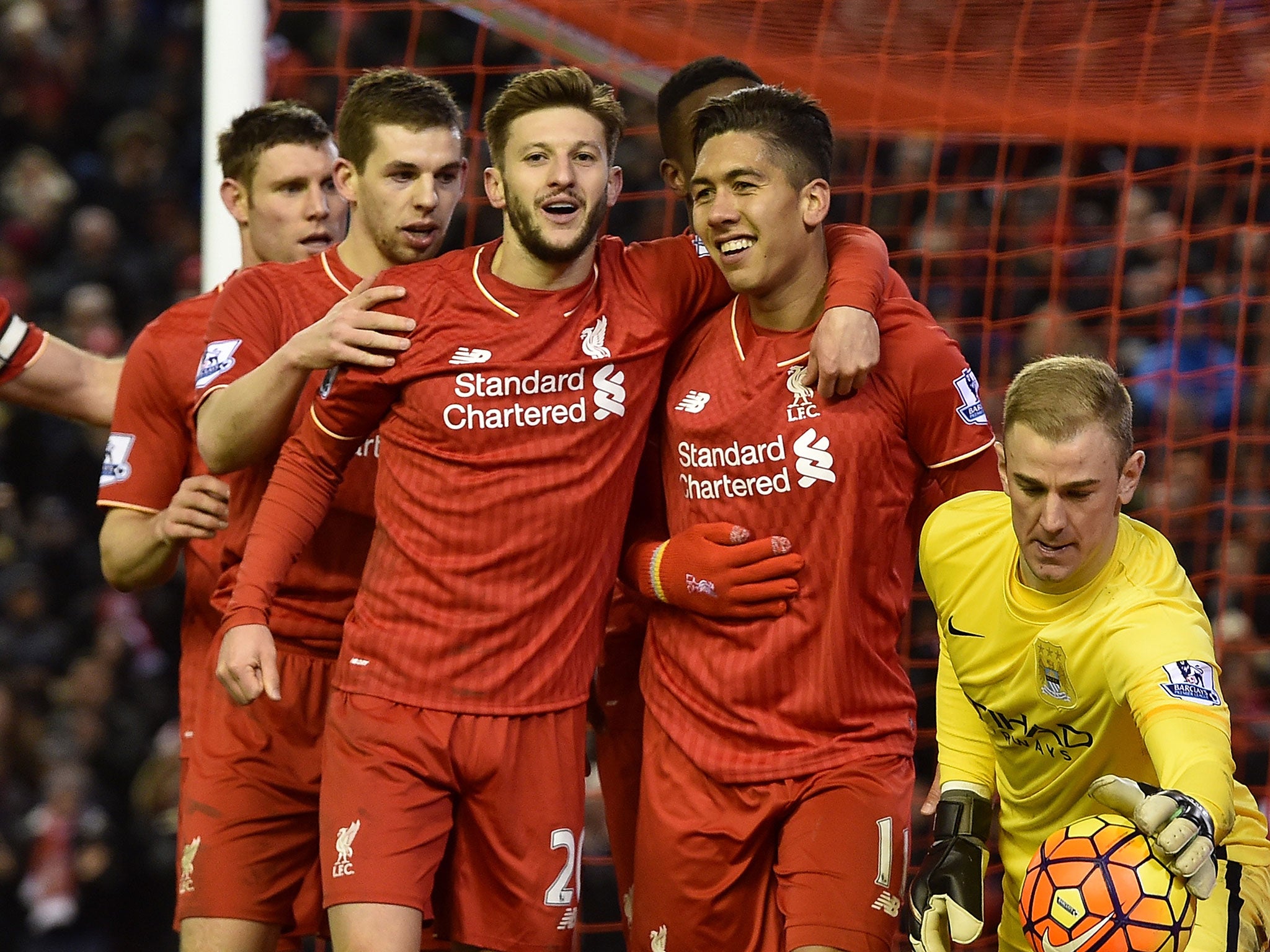 Roberto Firmino is congratulated on his goal