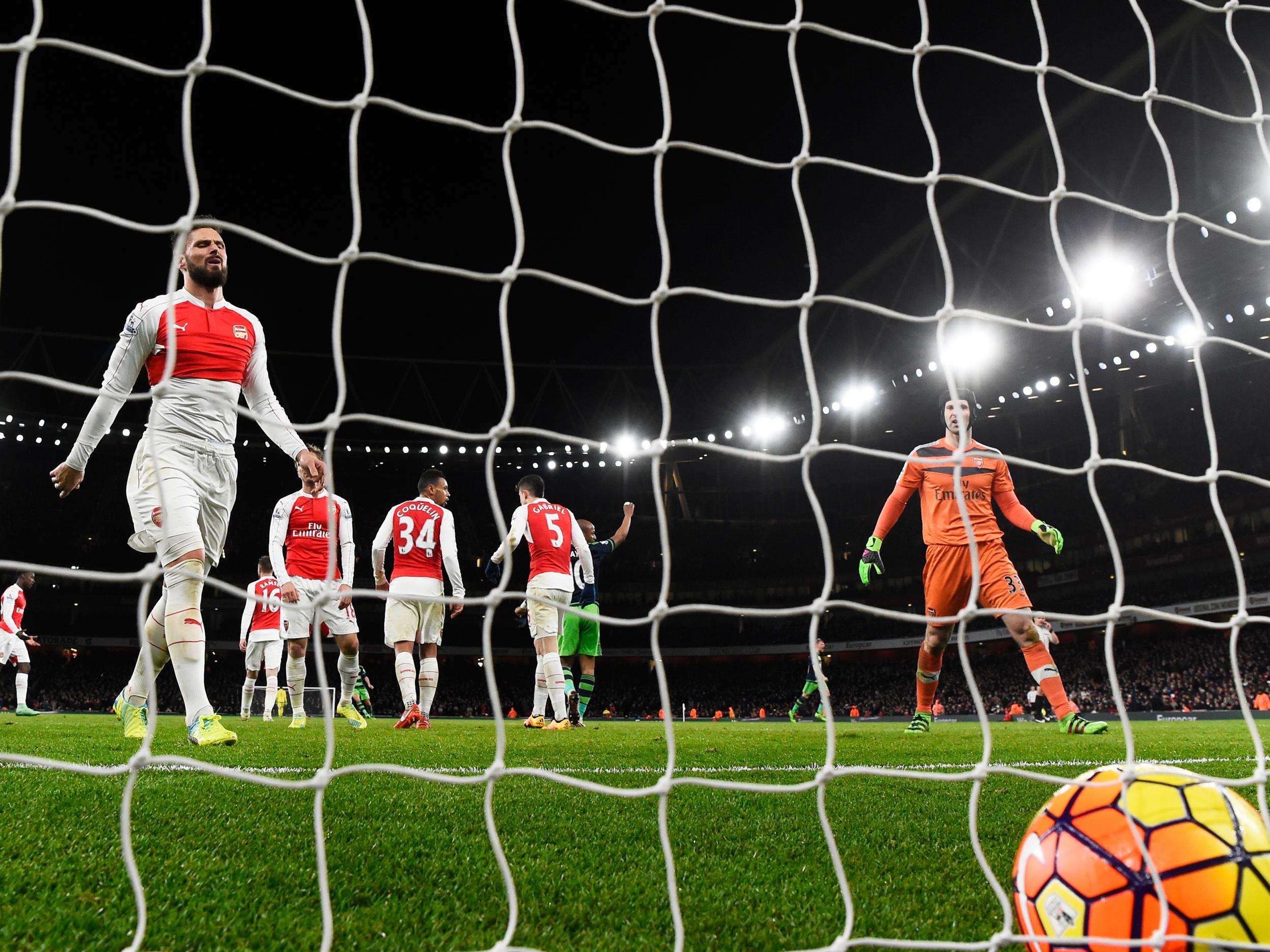 Arsenal players look on as Ashley Williams scores a winner for Swansea