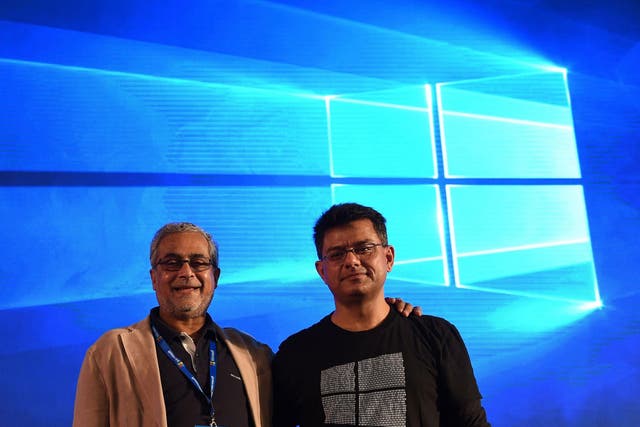 Chairman of Microsoft India Bhaskar Pramanik (L) poses with Director-Windows Business group Vineet Durani during the launch of Microsoft Windows 10 in New Delhi