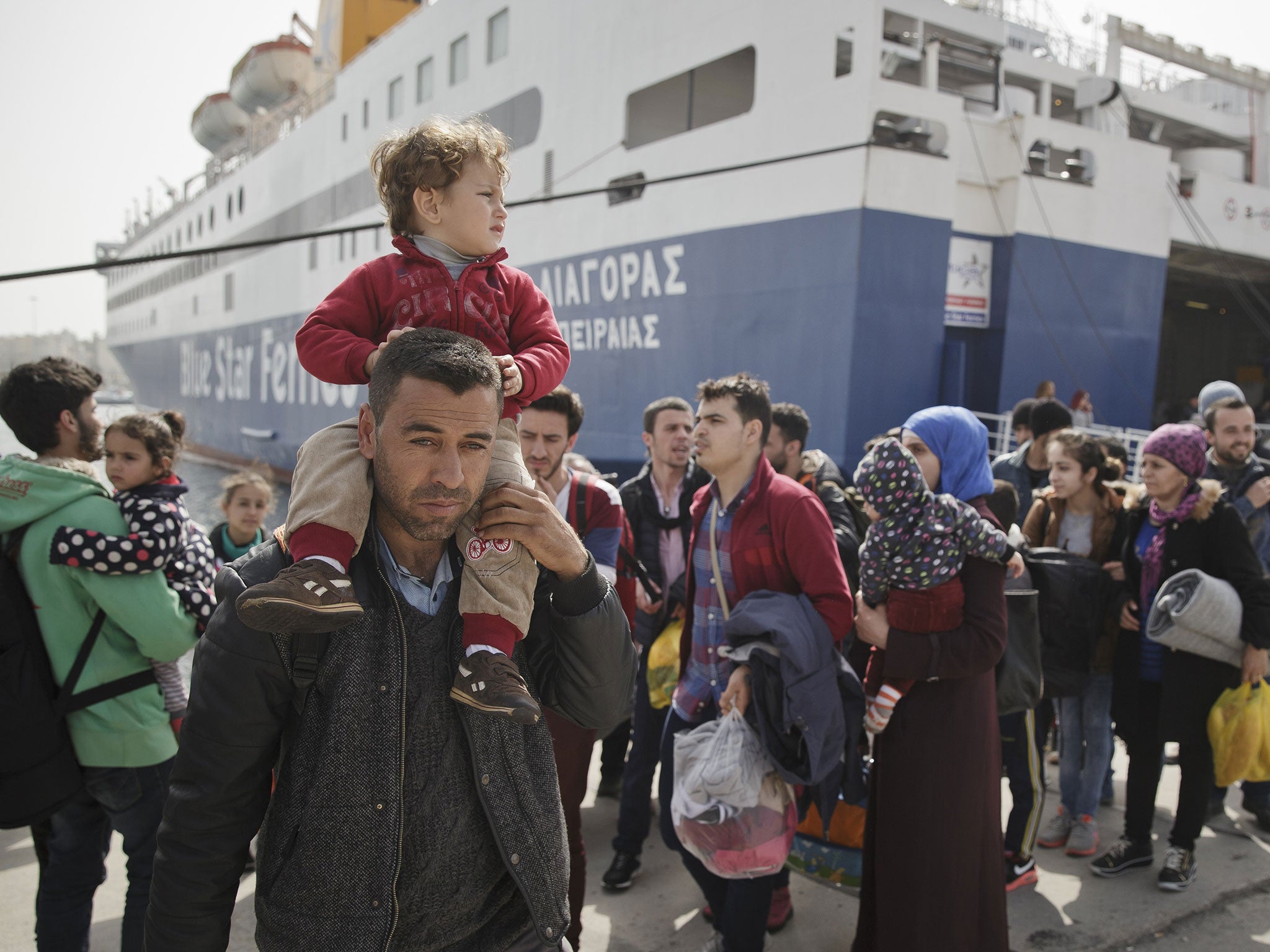 Refugees and migrants disembark from a ferry coming from Lesvos island, in the port of Piraeus, Greece, 01 March 2016.