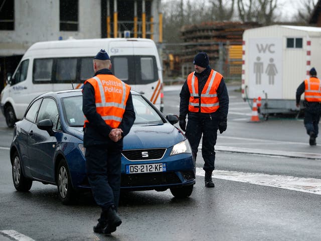 Belgian police officers check cars at the border between France and Belgium