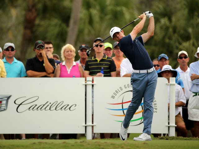 Rory McIlroy watches his tee shot on the 14th hole during the first round