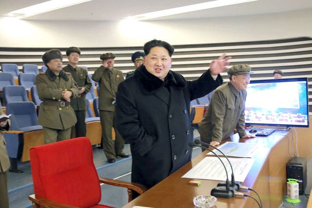 North Korean leader Kim Jong Un reacts as he watches a long range rocket launch in North Korea