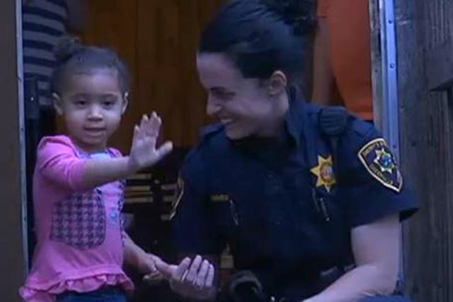 Two-year-old Aaliyah and sheriff’s deputy Martha Lohnes.