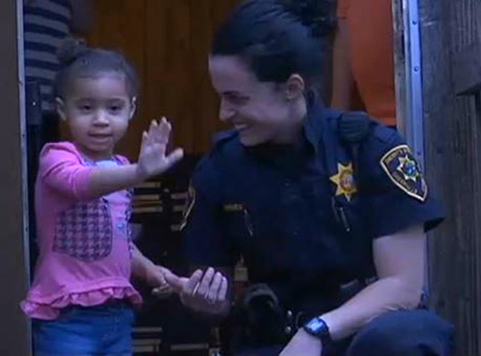 Two-year-old Aaliyah and sheriff’s deputy Martha Lohnes.