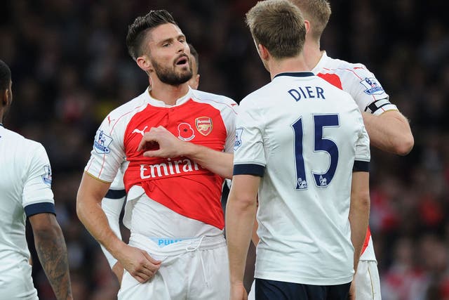Arsenal striker Giroud squares up to Tottenham midfielder Dier