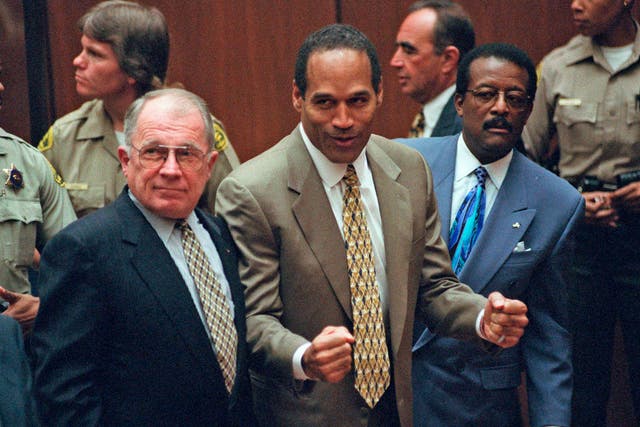 O.J. Simpson, center, reacts as he is found not guilty of murdering his ex-wife Nicole Brown and her friend Ron Goldman.