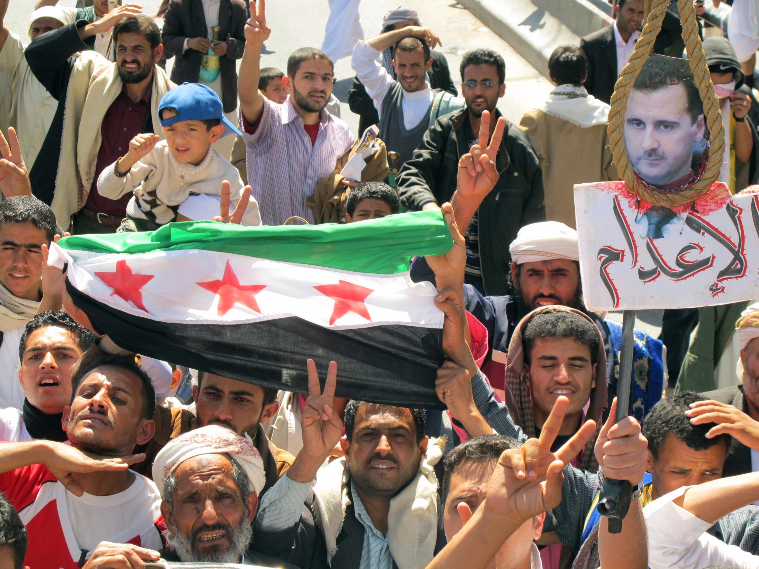 Waving the rebel Syrian flag and shouting slogans similar to the early days of the 2011 Syrian uprising