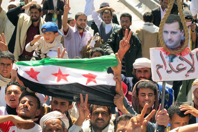 Waving the rebel Syrian flag and shouting slogans similar to the early days of the 2011 Syrian uprising