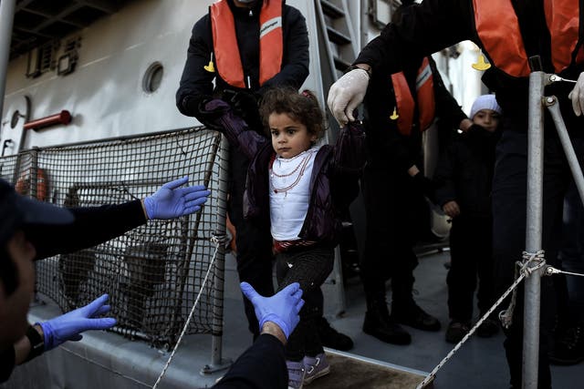 A migrant girl looks on upon arrival at the northern island of Lesbos after crossing the Aegean sea with other migrants and refugees from Turkey.