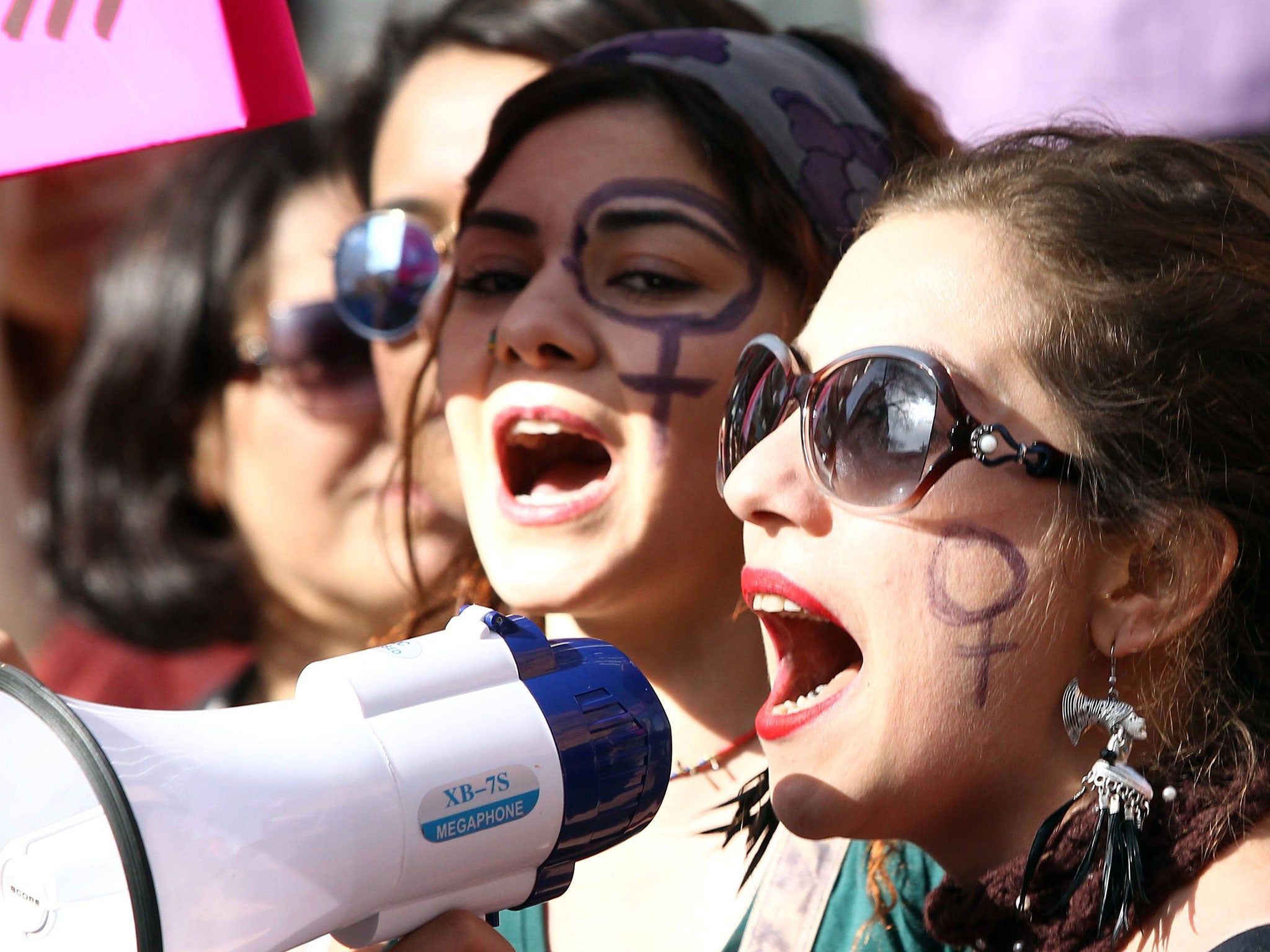 Turkish women shout slogans during a rally to mark International Women's Day in Ankara, on March 8, 2015.