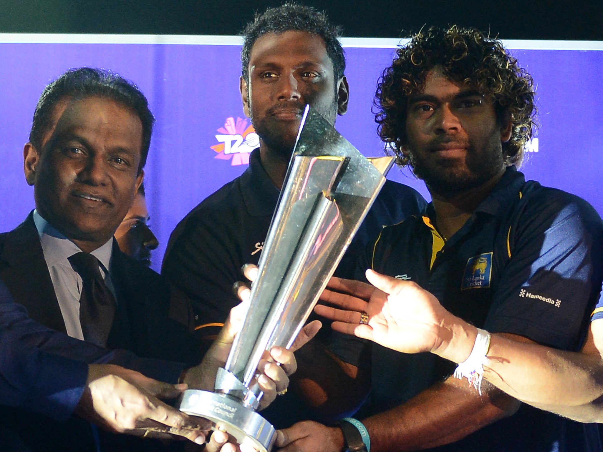 Sri Lankan T20 cricket captain Lasith Malinga, Angelo Mathews and president of Sri Lanka Cricket Thilanga Sumathipala hold the ICC 2016 World Twenty20 trophy
